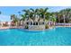 A community pool features a brick-lined waterfall feature and plentiful seating areas at 10922 Holly Cone Dr, Riverview, FL 33569