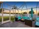 The covered patio offers comfortable outdoor seating and stylish lighting, perfect for entertaining guests at 10922 Holly Cone Dr, Riverview, FL 33569