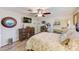 Bedroom featuring neutral walls, wood floors, mirrored closets, and a dresser with TV at 11035 Huron Rd, St Petersburg, FL 33708