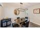 Modern dining room features a unique light fixture, a round mirror and seating for four at 11035 Huron Rd, St Petersburg, FL 33708