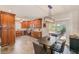 Open concept dining area featuring dark wood cabinets, a modern light fixture, and a sliding door at 11035 Huron Rd, St Petersburg, FL 33708