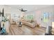 Inviting living room featuring hardwood floors, a comfortable sofa, and lots of natural light at 11035 Huron Rd, St Petersburg, FL 33708