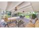 Relaxing covered patio with brick pavers, comfortable seating, and outdoor lighting for evening enjoyment at 11035 Huron Rd, St Petersburg, FL 33708