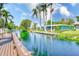 Beautiful waterfront view of the canal lined with lush greenery, palm trees, and well-maintained homes at 11035 Huron Rd, St Petersburg, FL 33708