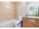 Well-lit bathroom with a granite-topped vanity and tiled walls surrounding the tub at 111 S Delaware Ave # 1, Tampa, FL 33606