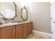 Bathroom featuring dual sinks, stone countertops, and hardwood cabinets at 111 S Delaware Ave # 1, Tampa, FL 33606