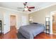 Bedroom with two entryways, a ceiling fan, and hardwood floors at 111 S Delaware Ave # 1, Tampa, FL 33606