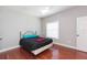 Bedroom with black comforter, window, ceiling fan, and hardwood floors at 111 S Delaware Ave # 1, Tampa, FL 33606