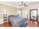Spacious bedroom featuring a ceiling fan, floor-to-ceiling mirror, and doors to a lanai at 111 S Delaware Ave # 1, Tampa, FL 33606