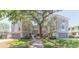 Beautiful townhouse exterior featuring a lush green lawn and manicured landscaping at 111 S Delaware Ave # 1, Tampa, FL 33606