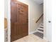 Welcoming foyer with tile flooring, stairway and a stylish wooden front door at 111 S Delaware Ave # 1, Tampa, FL 33606