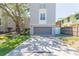 Two-story home with gray siding, a gray garage door, concrete driveway, and lush green lawn at 111 S Delaware Ave # 1, Tampa, FL 33606