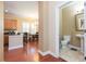 Open floorplan with hardwood floors connecting the kitchen, dining area, and a half bath at 111 S Delaware Ave # 1, Tampa, FL 33606