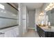 Spacious bathroom featuring double vanities, a glass-enclosed shower, and modern fixtures at 11432 Shoreline Trl, Parrish, FL 34219