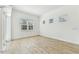 Bright bedroom with wood-look tile flooring and natural light from large windows at 11432 Shoreline Trl, Parrish, FL 34219