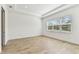 Bright bedroom featuring wood-look tile flooring and large window views at 11432 Shoreline Trl, Parrish, FL 34219