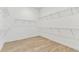 Walk-in closet with wooden floors and installed wire shelving at 11432 Shoreline Trl, Parrish, FL 34219