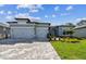 Charming single-story home featuring a three-car garage and well-manicured lawn at 11432 Shoreline Trl, Parrish, FL 34219
