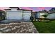 Charming home with a two-car garage, brick driveway, and manicured lawn at 11432 Shoreline Trl, Parrish, FL 34219