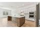 Spacious kitchen with modern appliances and a central island at 11432 Shoreline Trl, Parrish, FL 34219