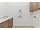 Laundry room with cabinets, sink and hookups at 11432 Shoreline Trl, Parrish, FL 34219