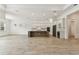 Open concept living space with a kitchen and wood-look tile flooring at 11432 Shoreline Trl, Parrish, FL 34219