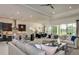 Spacious living area seamlessly connects to an open concept kitchen and dining area for modern living at 11432 Shoreline Trl, Parrish, FL 34219