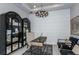 Modern office space featuring stylish furnishings, a chic light fixture, and sophisticated decor at 11432 Shoreline Trl, Parrish, FL 34219