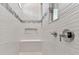 Elegant shower with textured white tile, built-in bench, and niche for storage at 11432 Shoreline Trl, Parrish, FL 34219