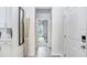 Bright hallway with gray tile, leading to a well lit living space at 11715 Blackbrook Ct, Seffner, FL 33584