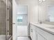 Modern bathroom featuring a white vanity, quartz countertops, and a glass-enclosed shower at 11723 Blackbrook Ct, Seffner, FL 33584