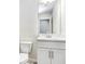 Cozy bathroom with a toilet and a vanity with white cabinets and countertops at 11723 Blackbrook Ct, Seffner, FL 33584