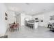 Open-concept living area with kitchen island, seating, dining table, and stainless steel appliances at 11723 Blackbrook Ct, Seffner, FL 33584