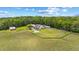 The property features a charming red barn and well-maintained landscaping at 12345 Citrus Way, Brooksville, FL 34601