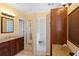 Bright bathroom featuring granite countertops, vanity, and a shower with a built-in seat and glass-block feature at 12345 Citrus Way, Brooksville, FL 34601
