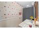 Charming bathroom featuring a single vanity, beach-themed wallpaper, and decorative lighting at 12345 Citrus Way, Brooksville, FL 34601