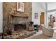 Close-up of a stunning stone fireplace with a wooden mantel, adding warmth and character to the living space at 12345 Citrus Way, Brooksville, FL 34601