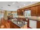 Spacious kitchen with hardwood floors, island, and granite countertops at 12345 Citrus Way, Brooksville, FL 34601