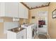 Laundry room equipped with modern appliances, including a washer and dryer, and ample cabinet space at 12345 Citrus Way, Brooksville, FL 34601