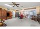Bright living room with entertainment center, sliding glass doors, and laundry access at 12345 Citrus Way, Brooksville, FL 34601