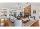 Spacious living room featuring a striking stone fireplace, hardwood floors, and sliding glass doors at 12345 Citrus Way, Brooksville, FL 34601