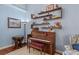 Cozy living room features a piano, shelving, and stylish decor at 12345 Citrus Way, Brooksville, FL 34601