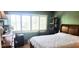 Bedroom with bed, dresser, and natural light from the large window at 1235 S Highland Ave # 5-402, Clearwater, FL 33756