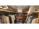 Walk-in closet with built-in shelving and rods for organized storage at 1235 S Highland Ave # 5-402, Clearwater, FL 33756