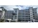 Multi-story condominium building with balconies and palm trees near the entrance at 1235 S Highland Ave # 5-402, Clearwater, FL 33756