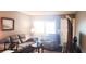 Comfortable living room showcasing a sofa, armchair, and bright natural light at 1235 S Highland Ave # 5-402, Clearwater, FL 33756