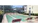 Recreational shuffleboard court with benches in well-maintained community area, surrounded by lush landscaping at 1235 S Highland Ave # 5-402, Clearwater, FL 33756