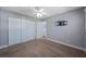 Bedroom features carpeted floors, a ceiling fan, and ample closet space at 12425 Touchton Dr # 77, Tampa, FL 33617