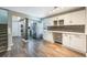 Open-concept kitchen and dining area featuring modern cabinetry and wood-look flooring at 12425 Touchton Dr # 77, Tampa, FL 33617