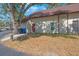 Well-lit exterior shot of a charming home with a brown roof and a neatly maintained front lawn at 12425 Touchton Dr # 77, Tampa, FL 33617